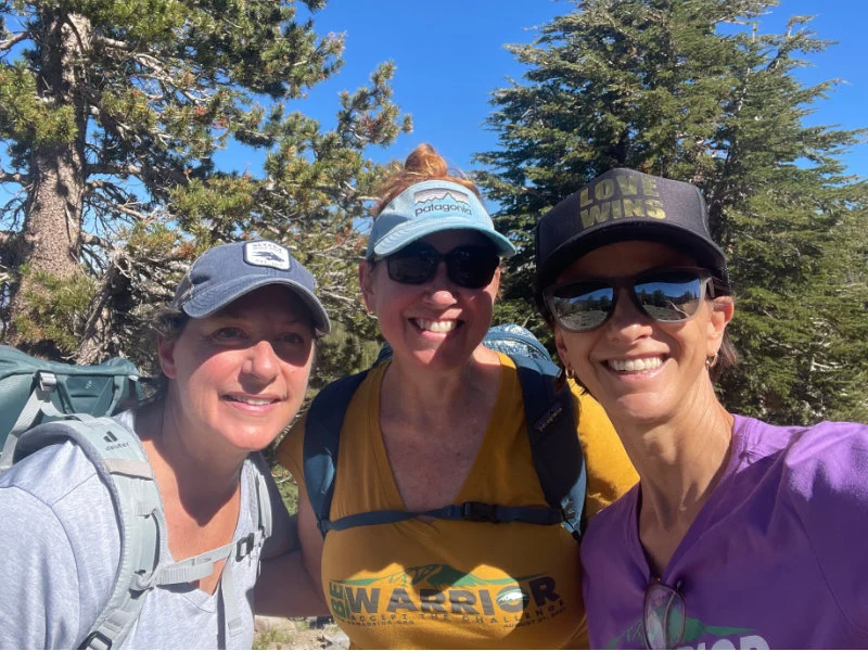 Three women hikers enjoy a hike on the Mount Rose Summit Trail during the Be Warrior Challenge Hike in 2023