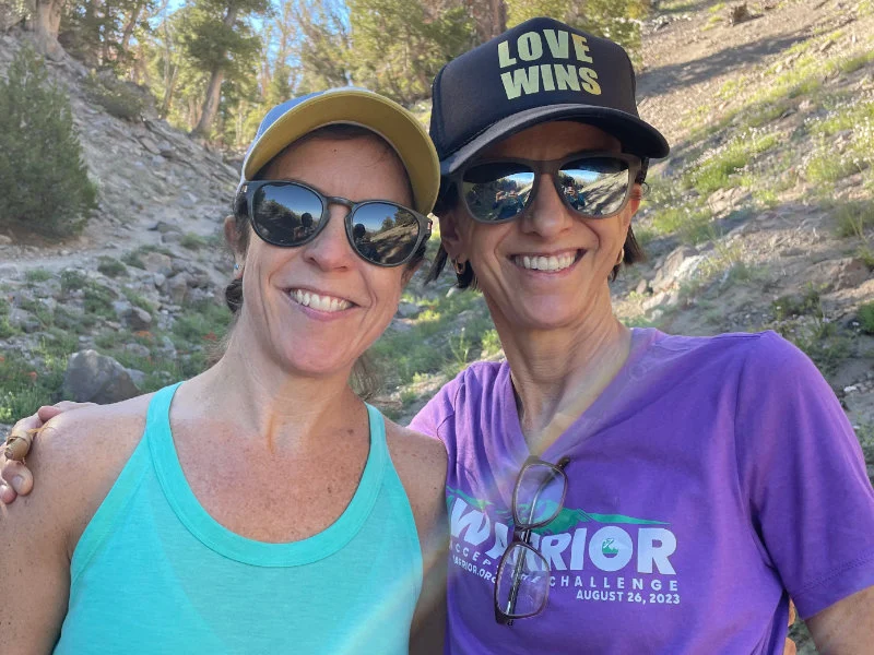 Two women hikers pose for a photo during the Be Warrior Challenge Hike on Mount Rose in 2023