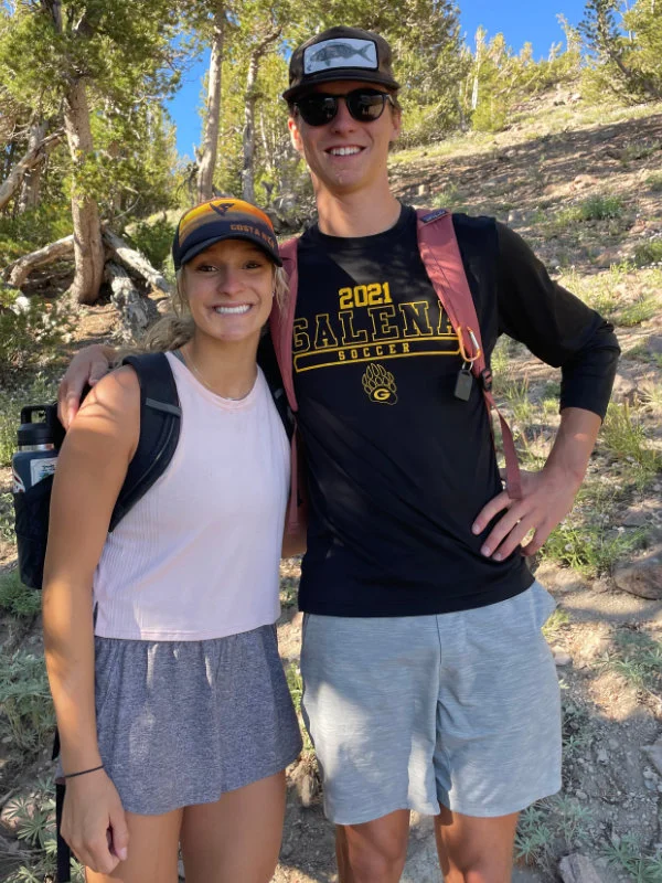 A young man and woman hiking at the 2023 Be Warrior Challenge Hike on Mount Rose in Nevada