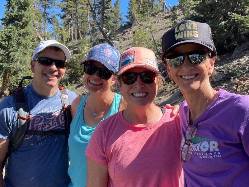 4 Hikers pose for a photo on the Mount Rose Summit Trail during the 2023 Be Warrior Challenge Hike