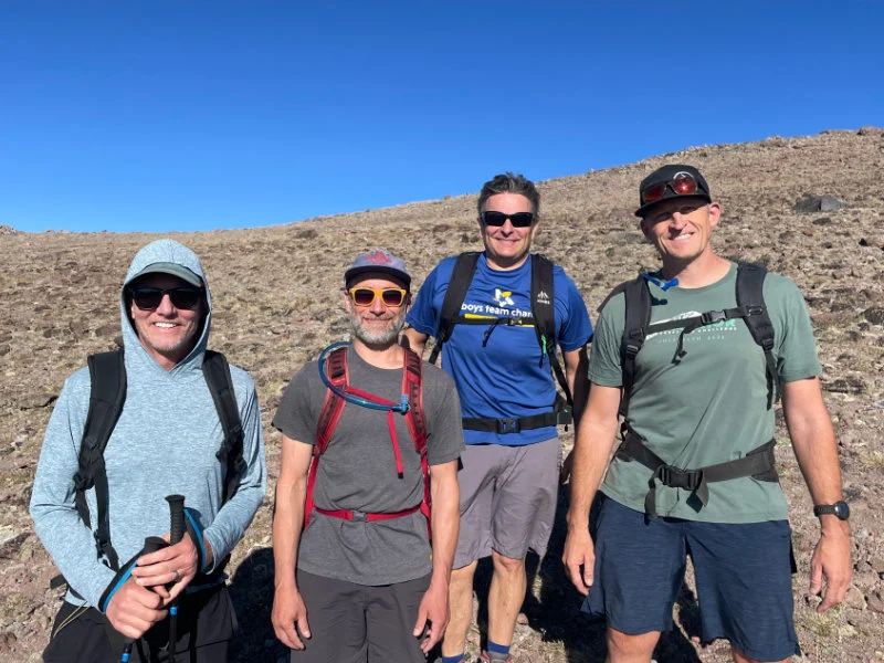 4 men hiking at the 2023 Be Warrior Challenge Hike on Mount Rose in Northern Nevada