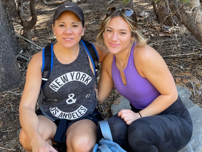 Two women take a rest during the 2023 Be Warrior Challenge Hike