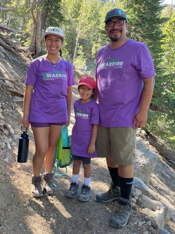 A young family poses for a picture on the Mount Rose Summit Trail during the 2023 Be Warrior Challenge Hike