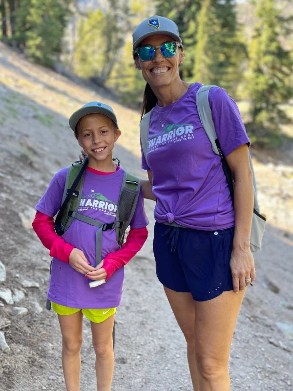A mom and daughter hike together on the trail to Mount Rose Summit during the 2023 B Warrior Challenge Hike