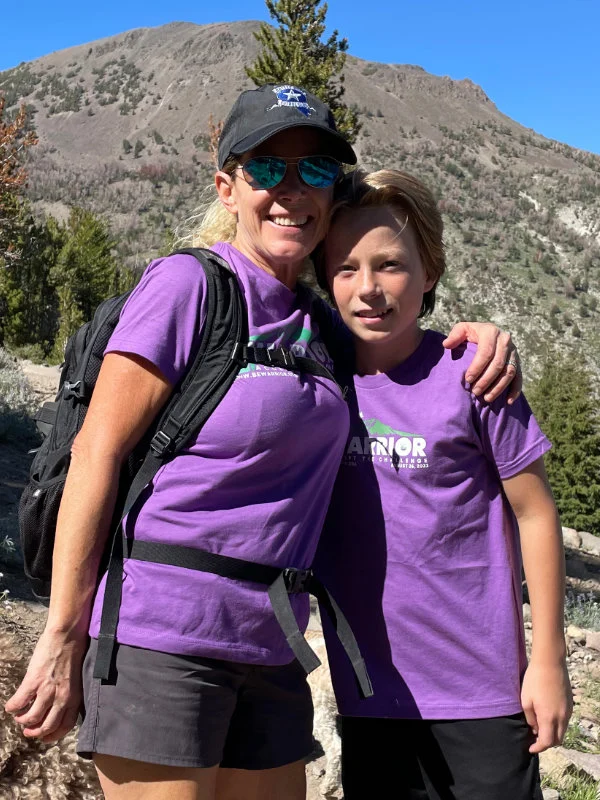 A woman and child hike together on the Mount Rose Summit Trail during the 2023 Be Warrior Challenge Hike